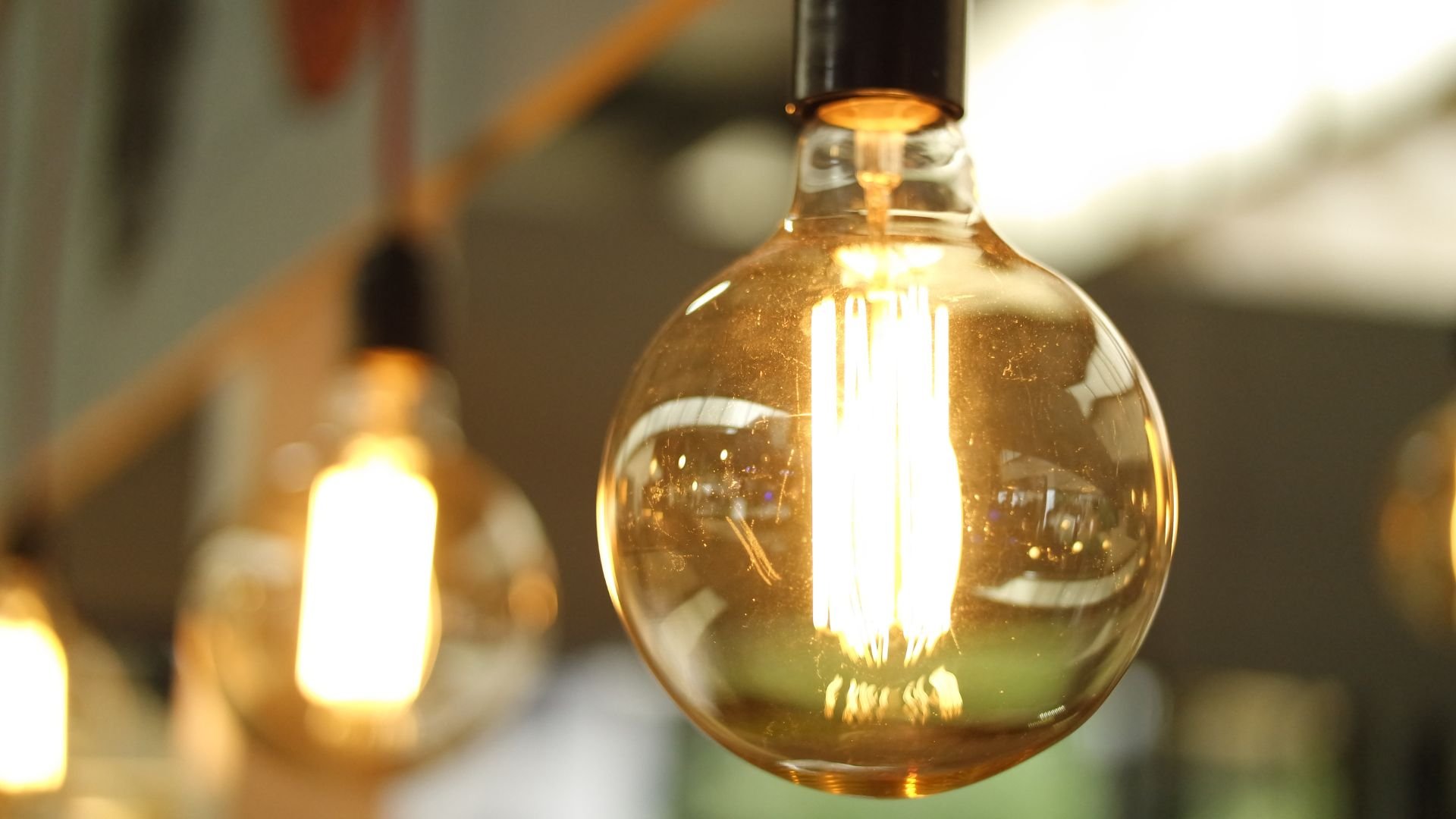 Glowing vintage filament light bulb with warm golden illumination
