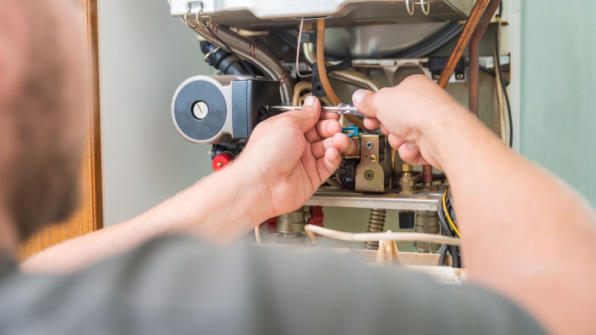 Technician repairing internal components of a mechanical system or appliance